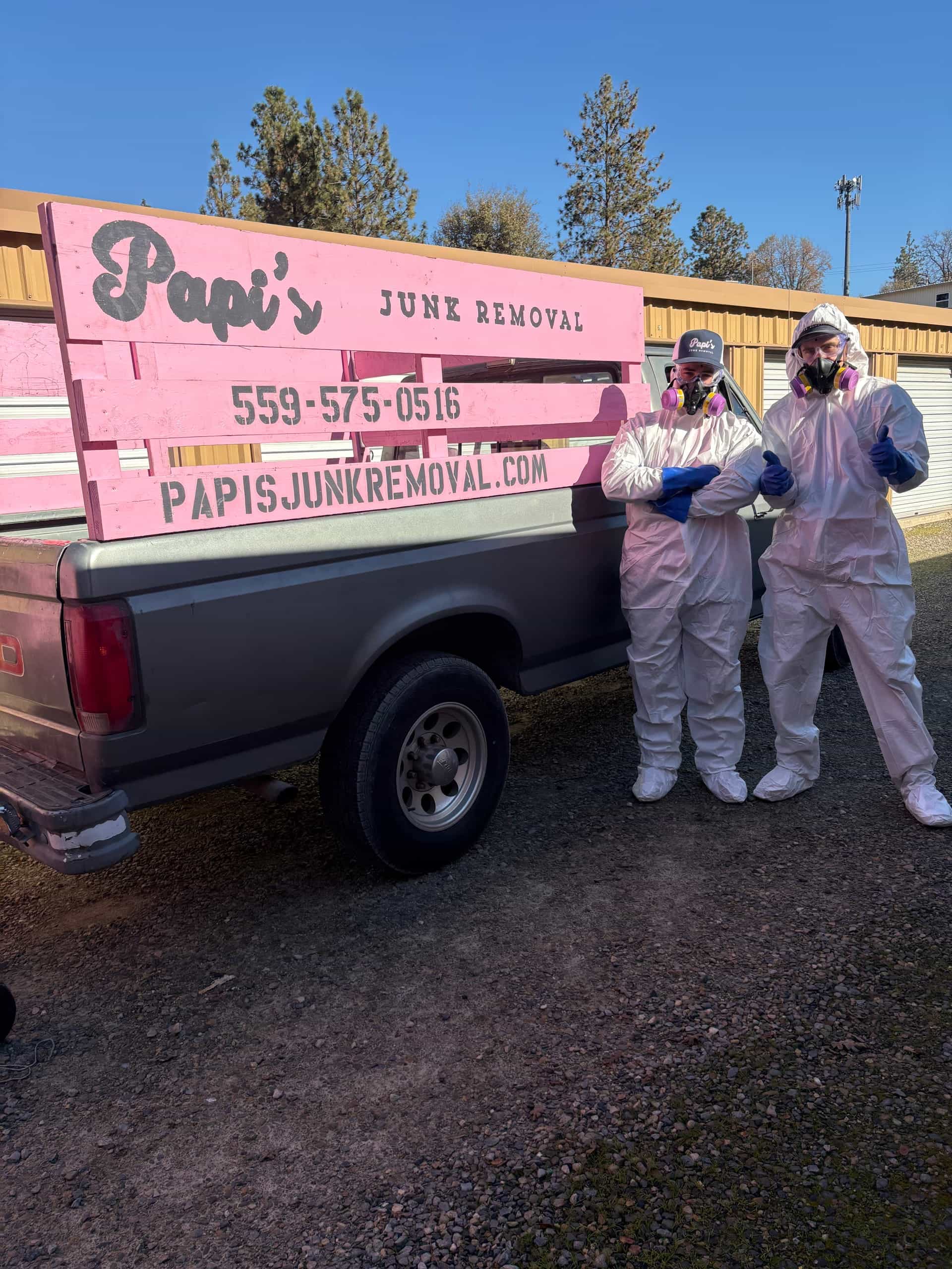 Two Papi's crew members in white protective suits ready for a heavy cleanout