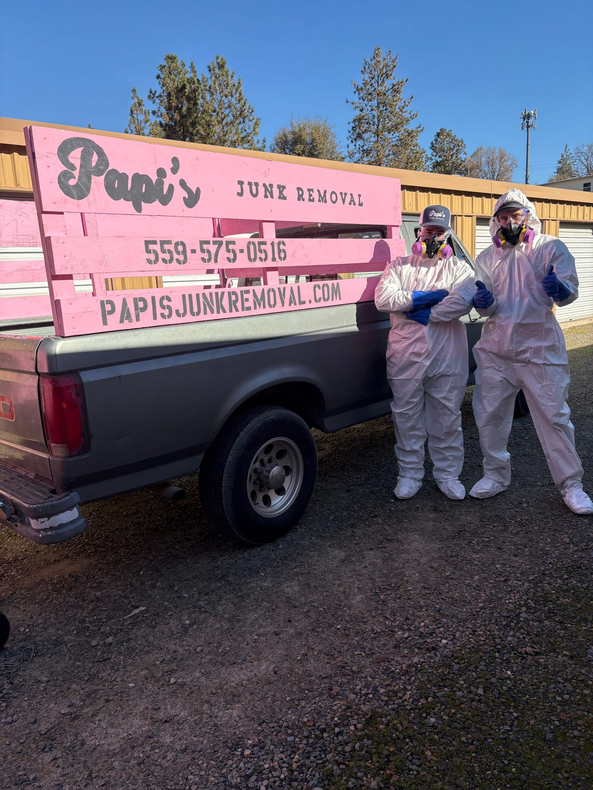 Two Papi's crew members in white protective suits ready for a heavy cleanout