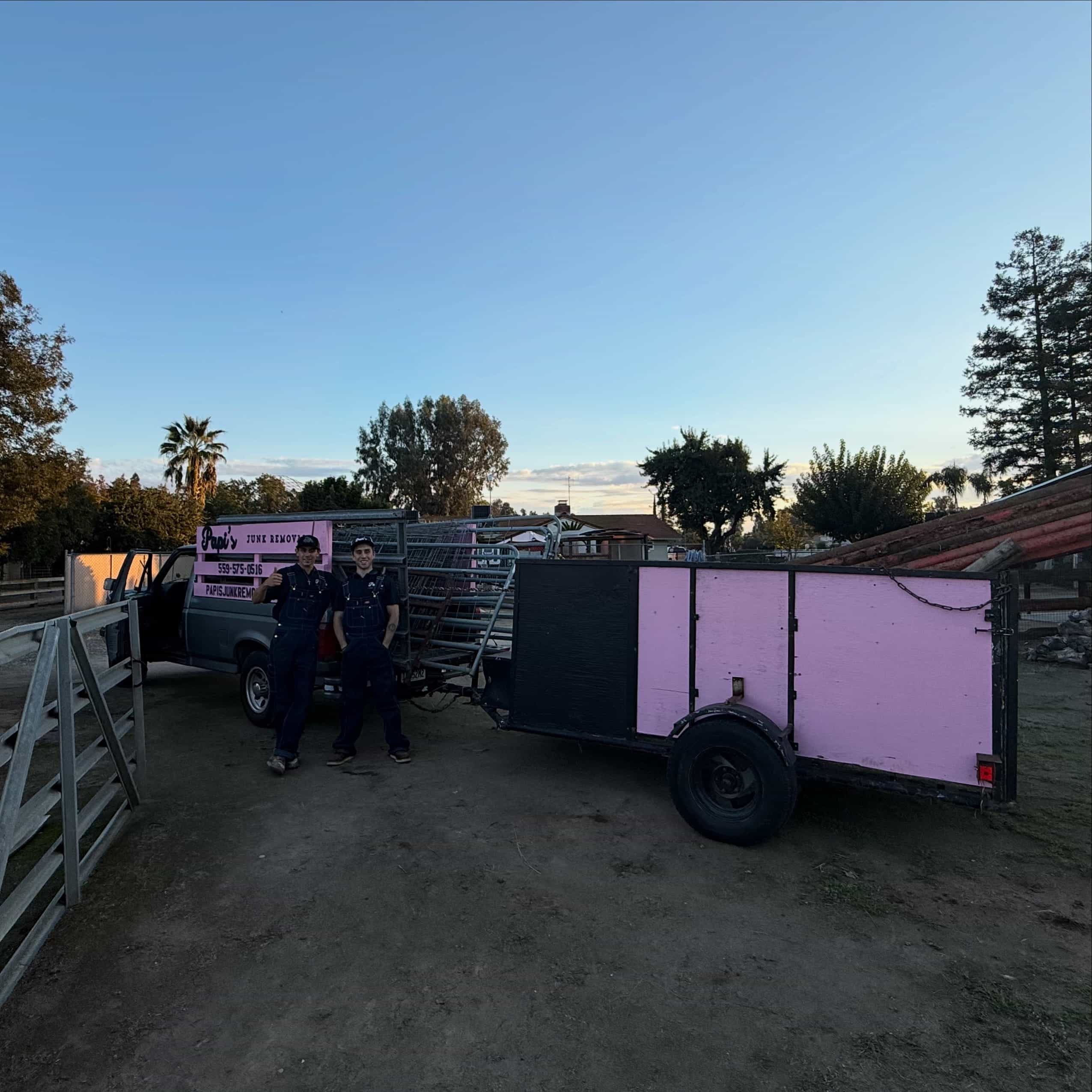 Two Papi's crew members with the truck and trailer on a rural lot like those west of Fresno toward Kerman
